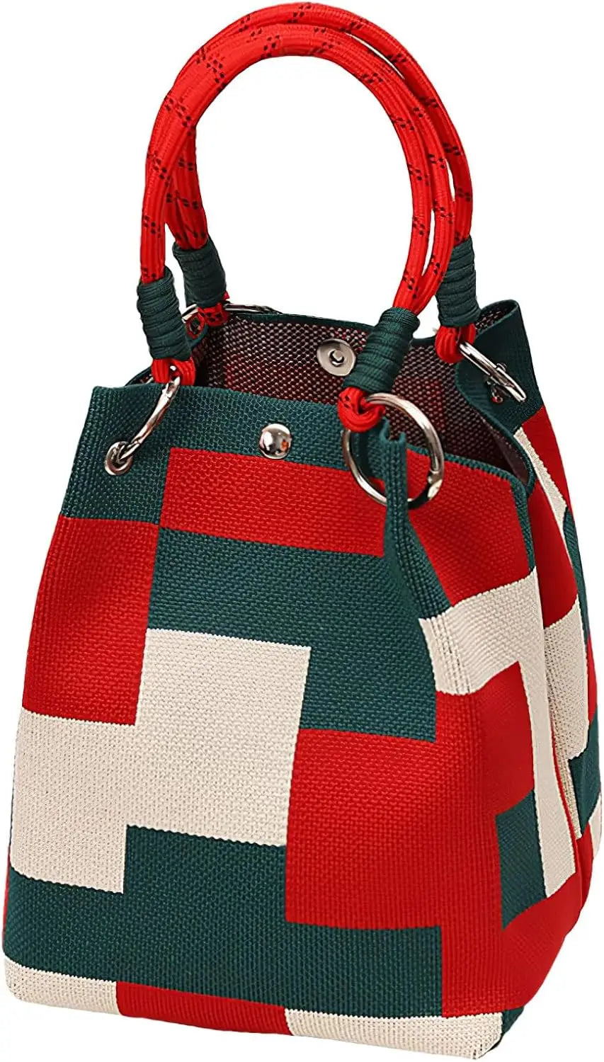 A red and white geometric colorblock knitted bucket bag with a red braided handle.