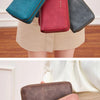 A collection of brown, black, and pink leather wallets are displayed in various angles and held by hands.