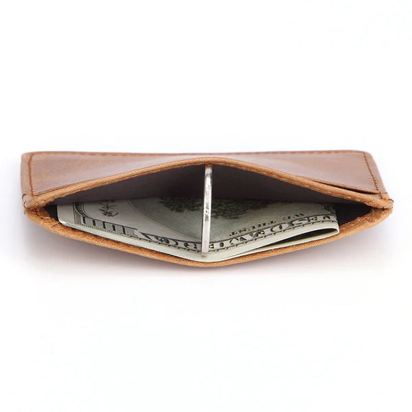 A brown genuine cow leather card holder wallet with a folded bill inside.
