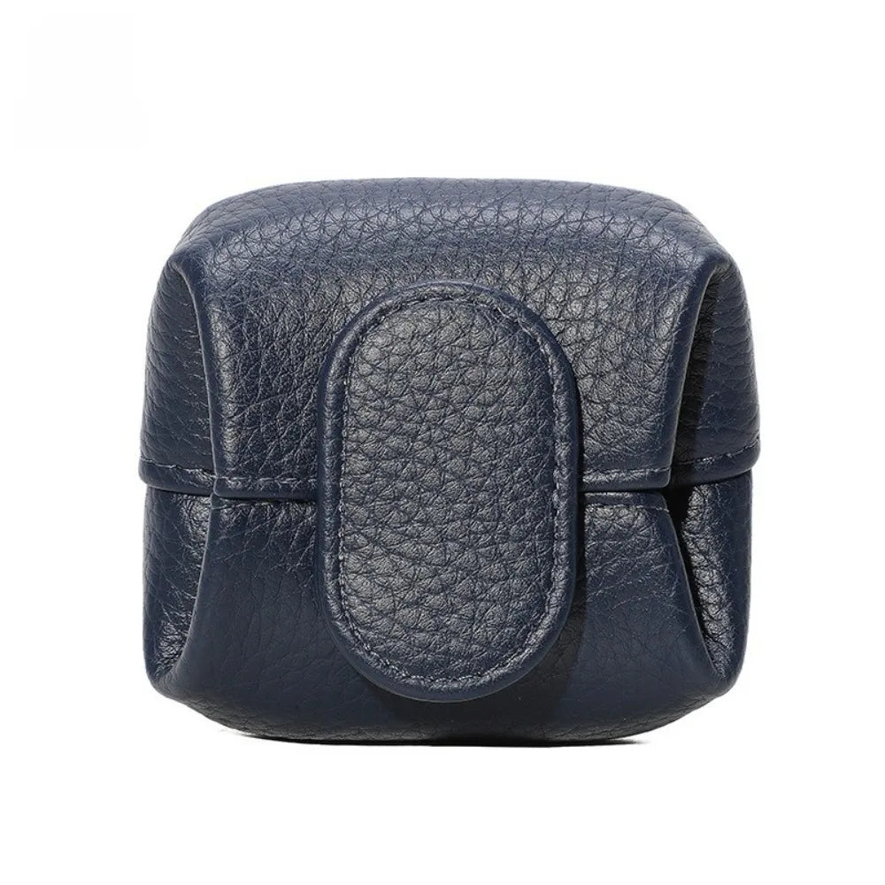 A dark navy blue compact coin purse with a textured leather finish and snap closure.