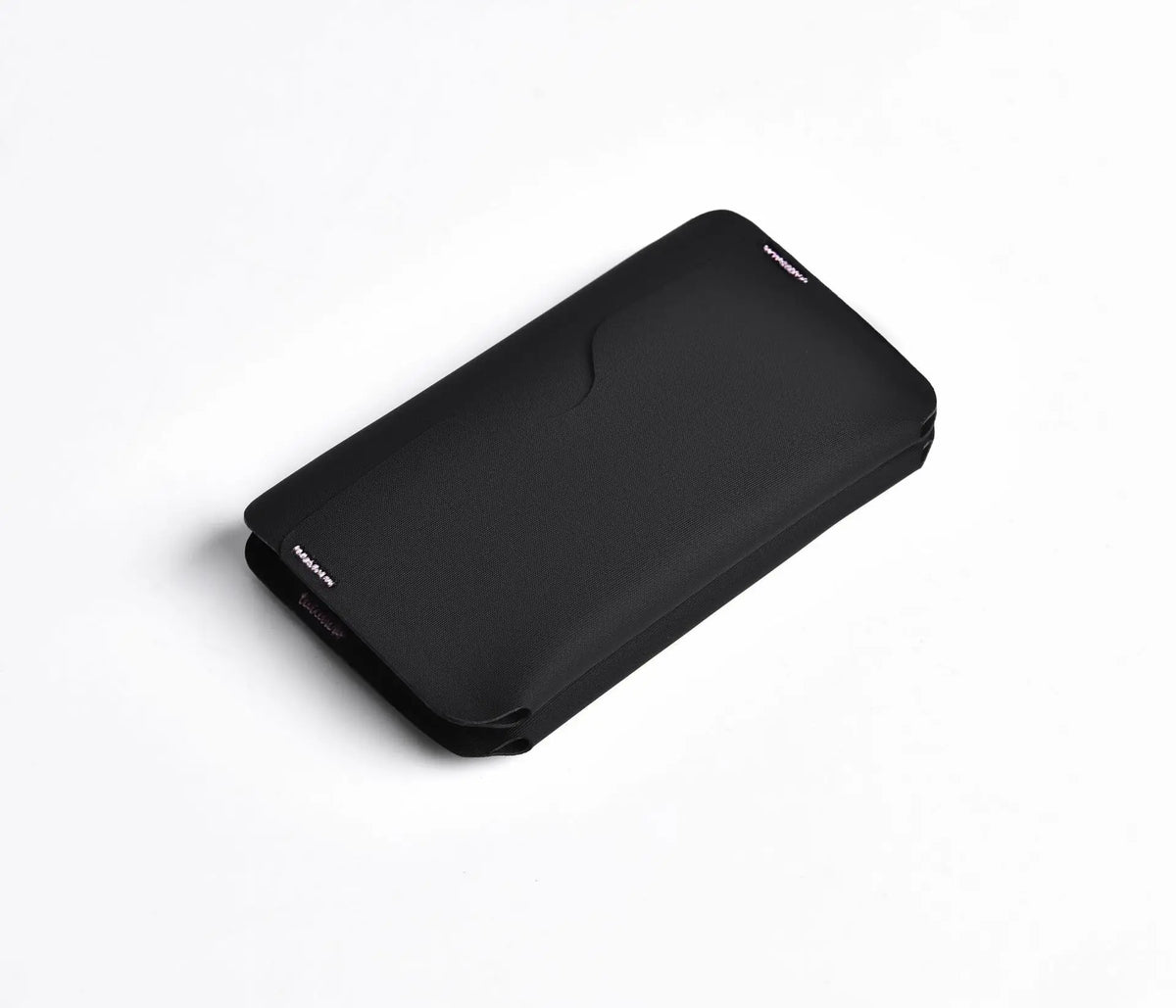 A black magnetic foldable ID card holder and coin purse shown from above.