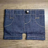 A dark indigo denim mini wallet and card holder with stitched seams and a silver snap closure.