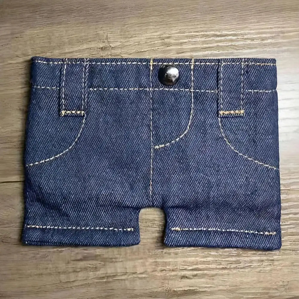 A dark indigo denim mini wallet and card holder with stitched seams and a silver snap closure.