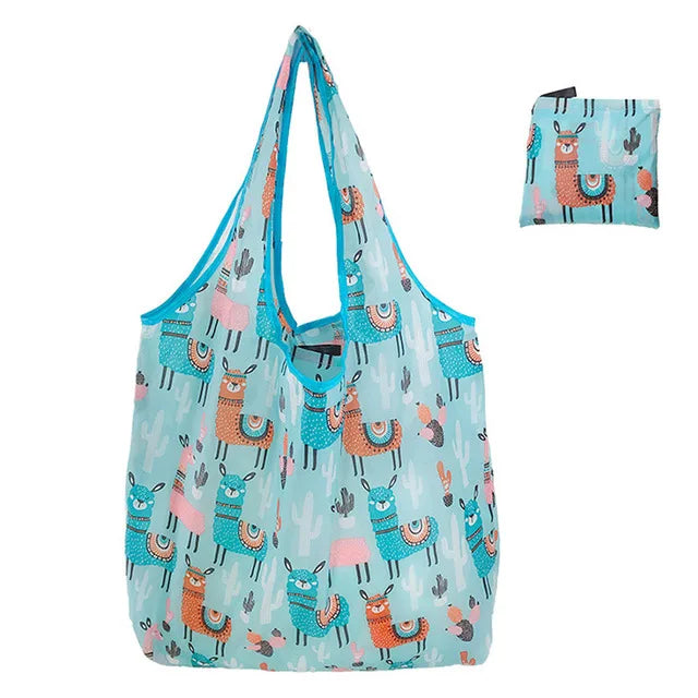A light blue reusable shopping bag featuring a pattern of stylized, colorful cacti and animals.