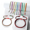 A display of various handmade braided rope bracelets in colorful shades and colors.