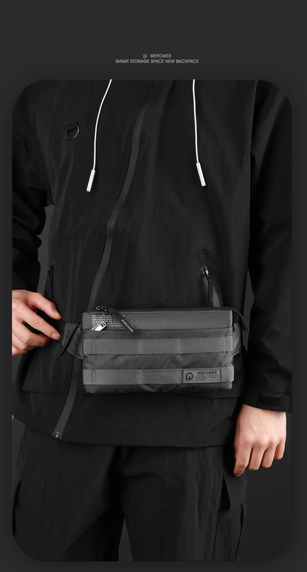 A person wearing a black long-sleeved shirt is holding a gray chest bag from the front.
