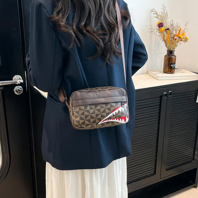 A dark blue blazer and white skirt are shown next to a brown leather square crossbody purse.