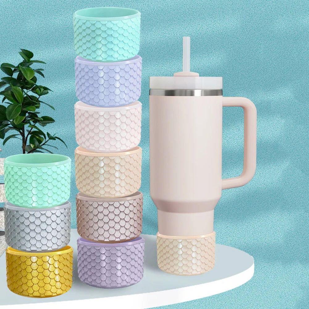 A stack of colorful silicone boot sleeves and a pink insulated water bottle are displayed against a light blue background.