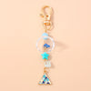 Gold-toned starfish keychain with pearl accents and a triangular charm