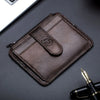 A brown genuine leather RFID blocking card holder is shown diagonally on a dark surface.