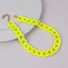 A bright yellow acrylic chain necklace with a gold-colored clasp displayed on a white background.