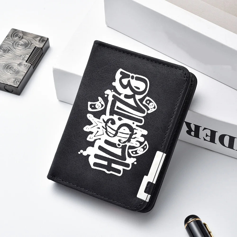 A black PU leather wallet with a white cartoon print is shown next to a silver box and a pen.