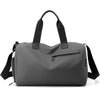 A gray waterproof travel duffle bag with black straps and a separate shoe compartment.
