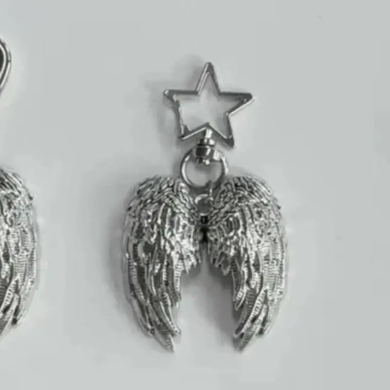Silver metal angel wing charm with a star pendant on a keyring.