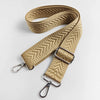 A tan woven leather handbag strap featuring an arrow jacquard pattern with silver hardware.
