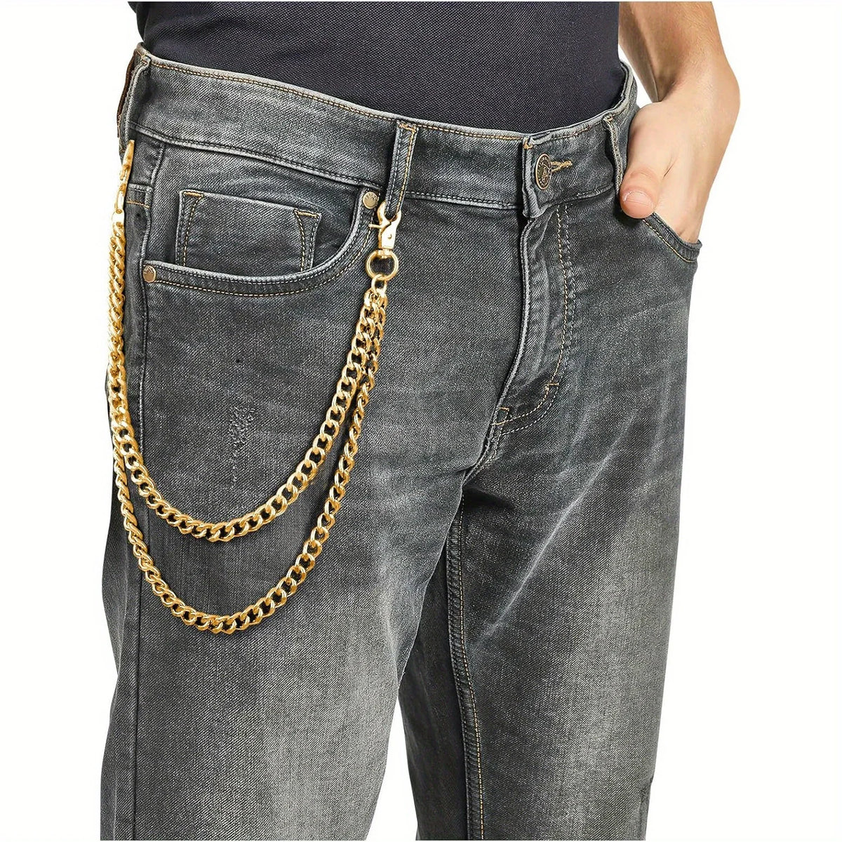 Graue Jeanshosen mit goldfarbener Krabben-Schlüsselkette, die an die Tasche befestigt ist.