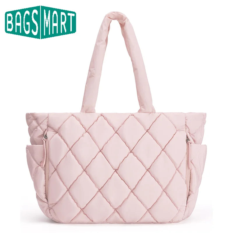 A light pink quilted puffy tote bag with a handle and laptop compartment.