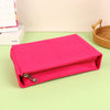 A bright pink felt cosmetic bag insert organizer lying on a light green surface.