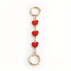 Gold-toned metal chain shoulder strap extension with three heart charms.