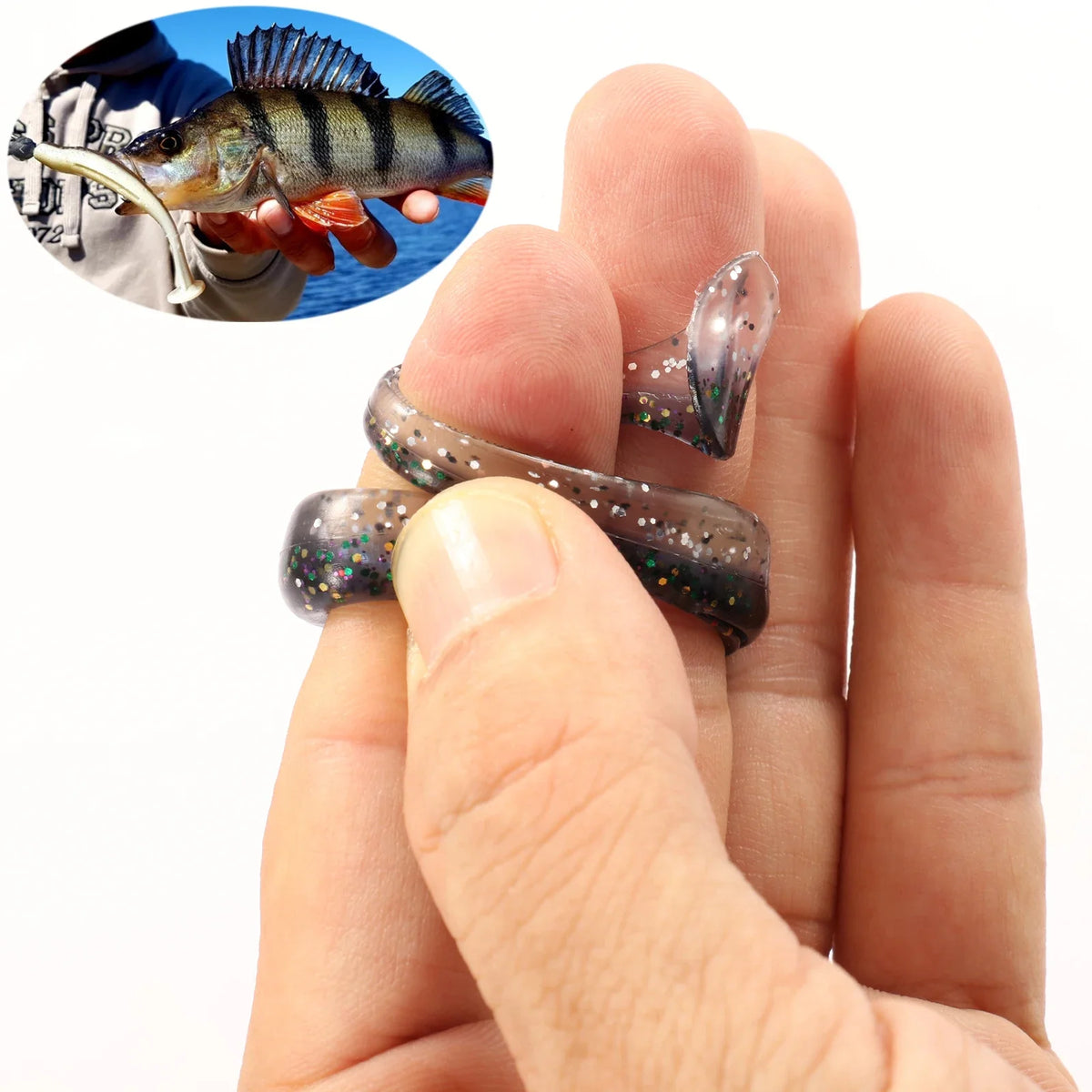 A hand holds an adjustable soft lure fishing tackle, featuring a shiny, dark body and iridescent speckles.