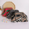 Three knitted clip bags in vibrant colors and patterns are displayed on a white surface.