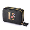 Black faux leather mini wallet with a gold letter H print and floral embellishments and a double zipper