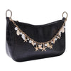 Black faux leather handbag with a gold chain featuring pearl and starfish charms