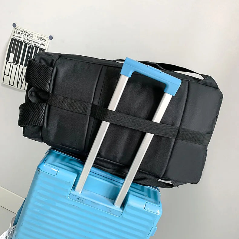 A black waterproof travel gym backpack with light blue skateboard straps resting on a light blue box.