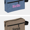A light blue fabric cosmetic bag embroidered with the name Belle