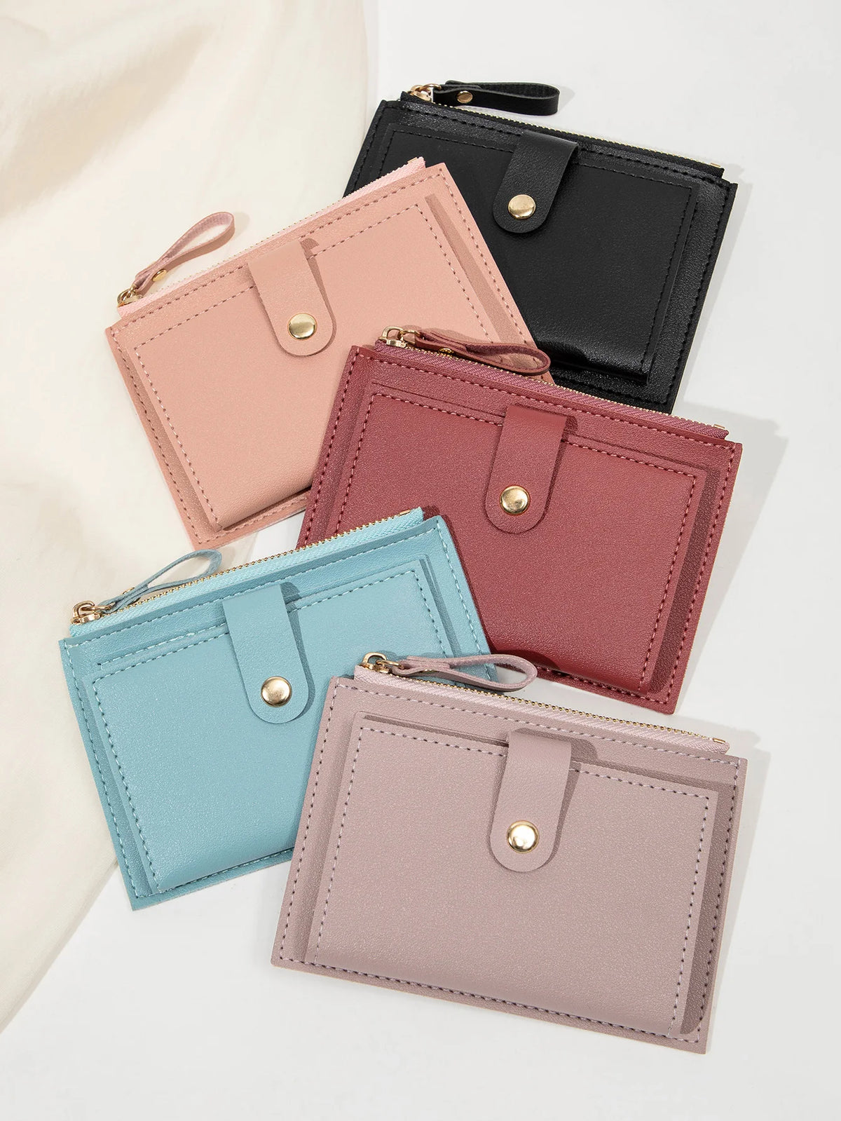 A collection of five ultra-thin PU leather card holder wallets in shades of pink, mauve, and black.