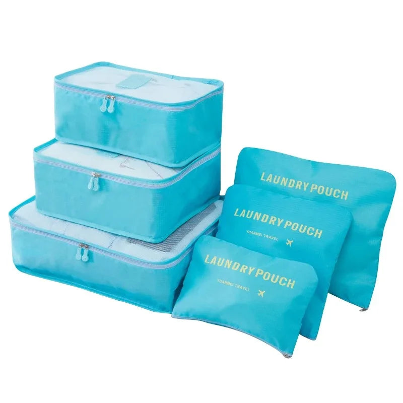 A set of light blue mesh laundry pouches and packing cubes for travel organization.