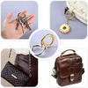 Stainless steel spring clasp keychain rings in a pack with a brown leather purse and a brown leather bag