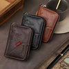 A collection of brown and black vintage PU leather slim wallets with gold accents resting on a dark surface.