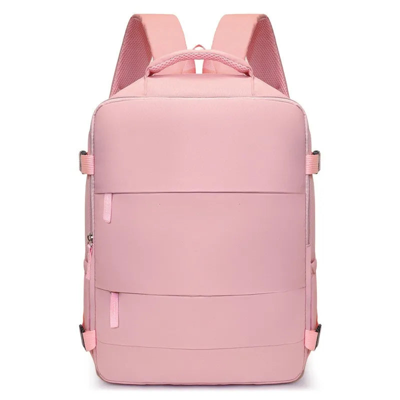 A pink compact travel backpack with pink straps and multiple storage compartments.
