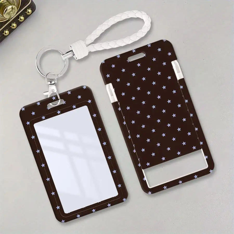 A black card holder with a clear window and a lanyard featuring white stars is displayed on a light gray surface.