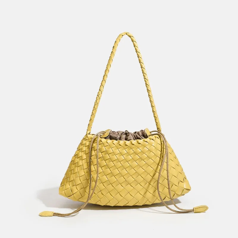A yellow handwoven PU shoulder bag with a woven texture and long braided straps.