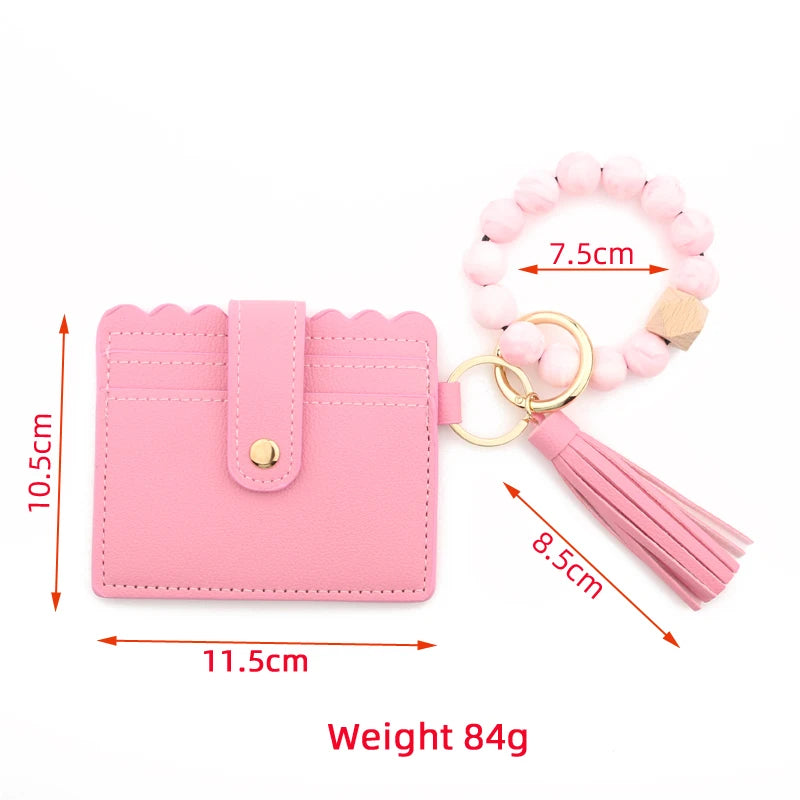 Pink silicone bead bracelet and leather card holder with tassel attached