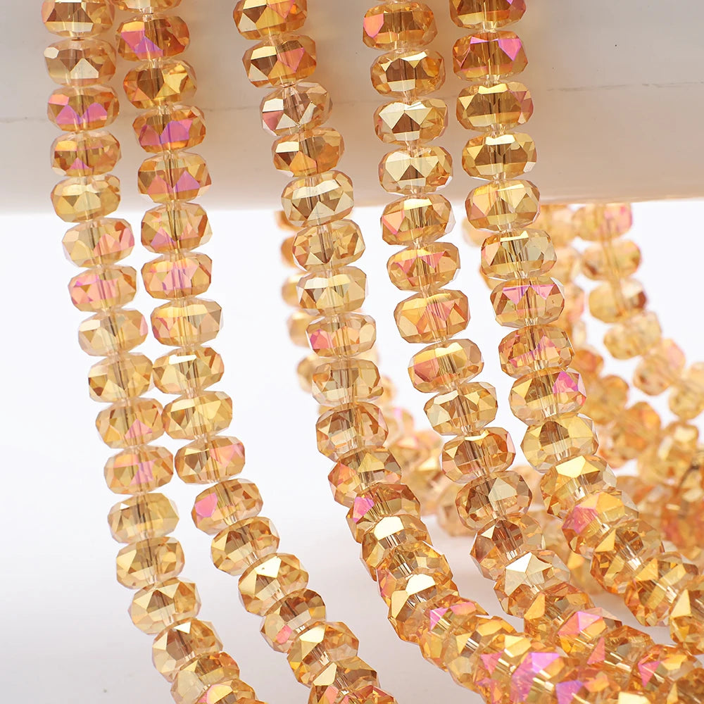 A close-up of strands of yellow and orange faceted crystal glass beads for jewelry making