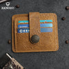 A brown genuine leather card wallet with embossed floral patterns and multiple slots for cards is displayed on a dark gray su