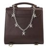 A dark brown leather purse with a silver metal chain strap featuring a dragonfly charm.
