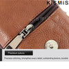 Close-up of a brown leather bag featuring a silver zipper and belt clip detail.