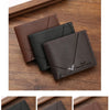 A set of slim men's leather RFID blocking bi-fold wallets in black, coffee, and brown colors displayed on a wooden surface.