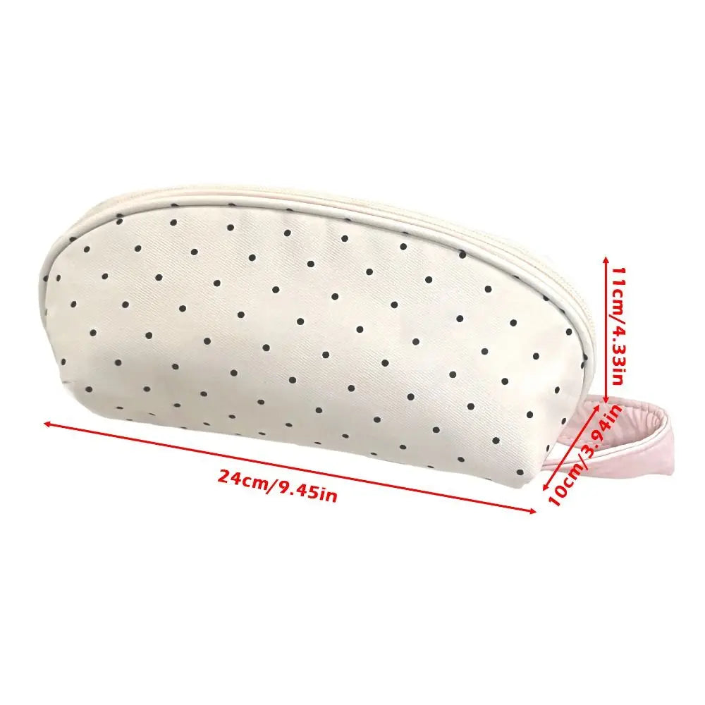 A cream-colored shell pencil case with a polka dot pattern, shown flat with dimensions.