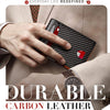 A hand holds a black carbon leather slim wallet against a light suit jacket, emphasizing durability and protection.