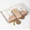 A beige fashion PU leather slim card holder wallet with a floral pattern and gold-toned coins.