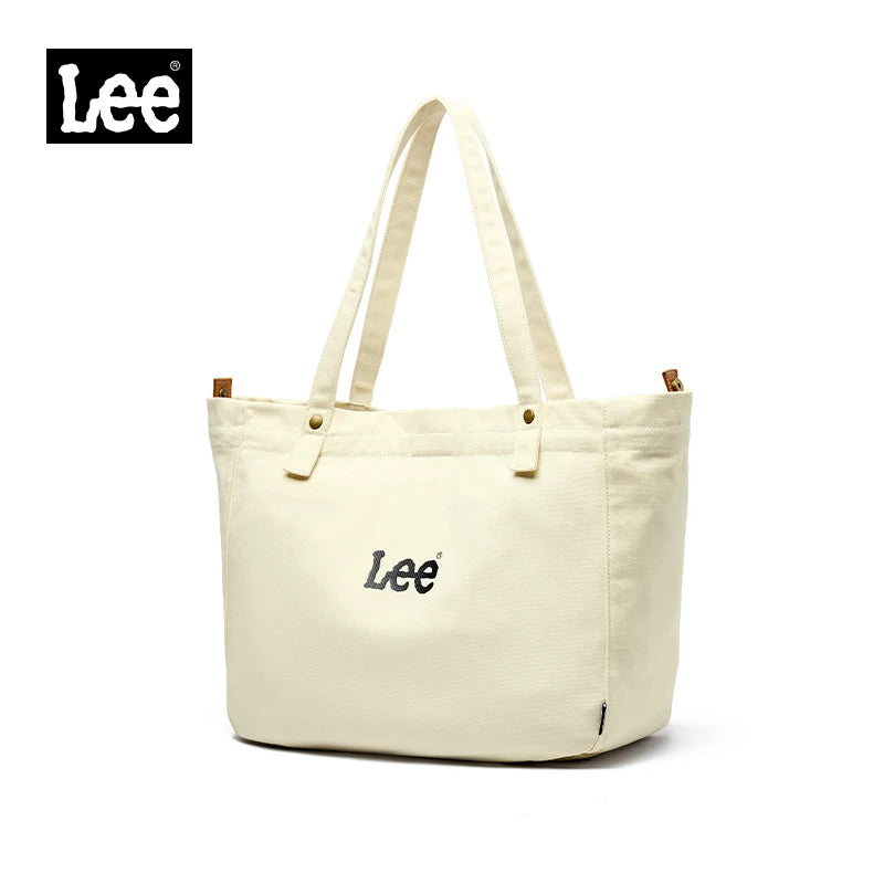 A cream-colored Lee Oxford cloth tote bag with light beige handles and a small embroidered logo.