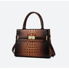 A brown crocodile embossed PU leather shoulder handbag with a gold-toned buckle and strap.