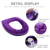 Detail display of a purple plush toilet seat cover showing the zipper and plastic zipper.