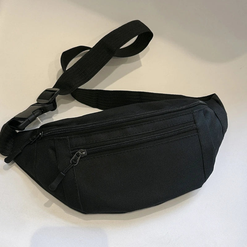 Black compact nylon waist bag with a strap, shown from above.