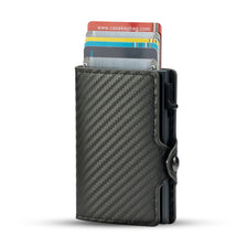 A black carbon fiber RFID pop-up card holder displaying several credit cards.